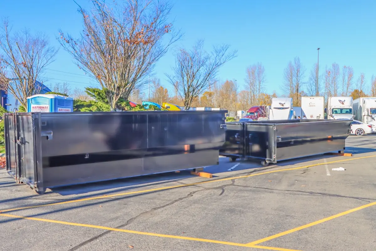 Professional dumpster rental service with roll-off container on residential driveway in Corning